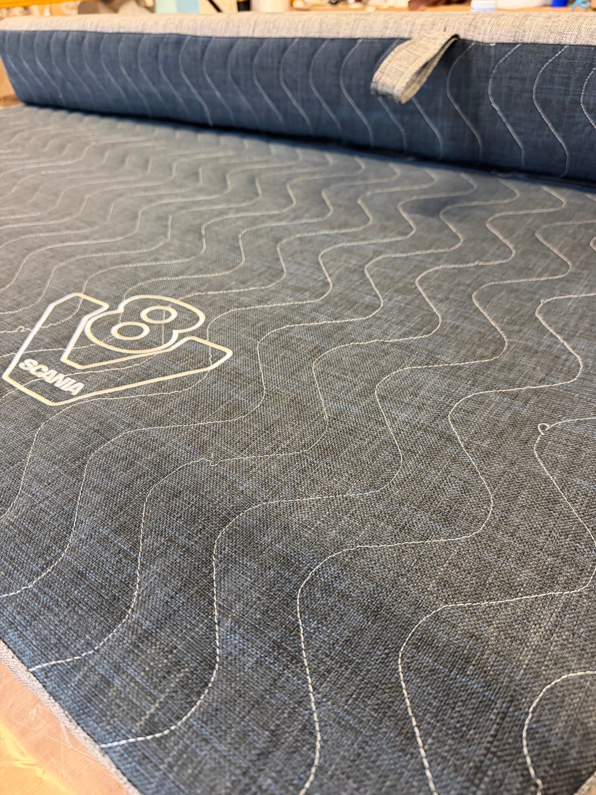 Scania Next Gen truck mattress topper folded at its hinge to show how the two-part design moves with the pull-out sleeper bed